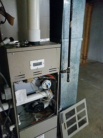 Furnace with the front panel removed revealing electronics inside
